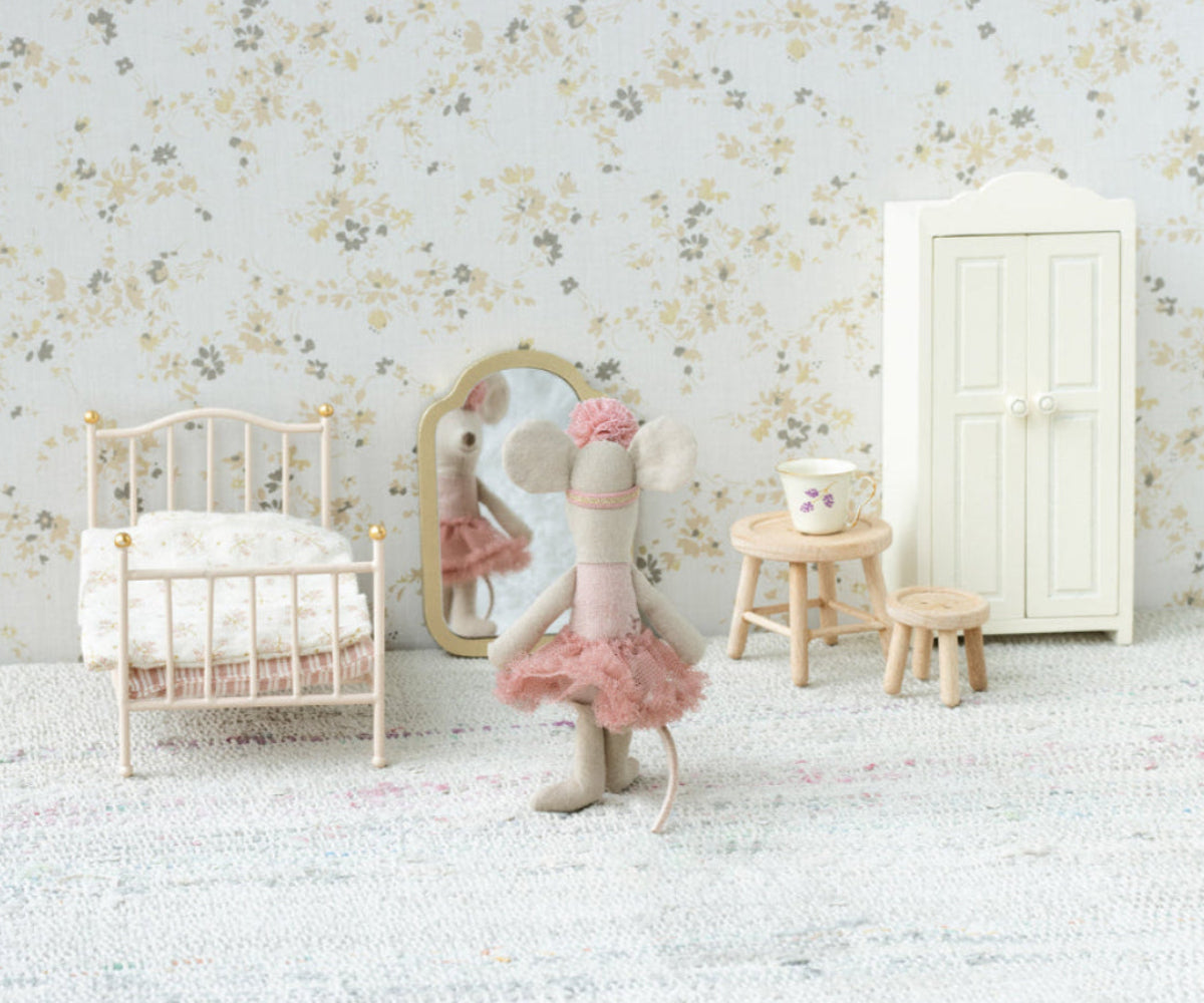 Maileg Little Sister Ballerina Mouse doll from doll house collection, dressed in a pink tutu and ballet shoes, standing indoors.