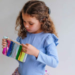 Colorful metallic stripe purse by Mimi & Lula, accessories bag with vibrant rainbow-colored stripes and shiny metallic finish.