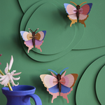 Colorful butterflies DIY wall art from Studio Roof featuring vibrant paper butterflies arranged for arts and crafts decor.