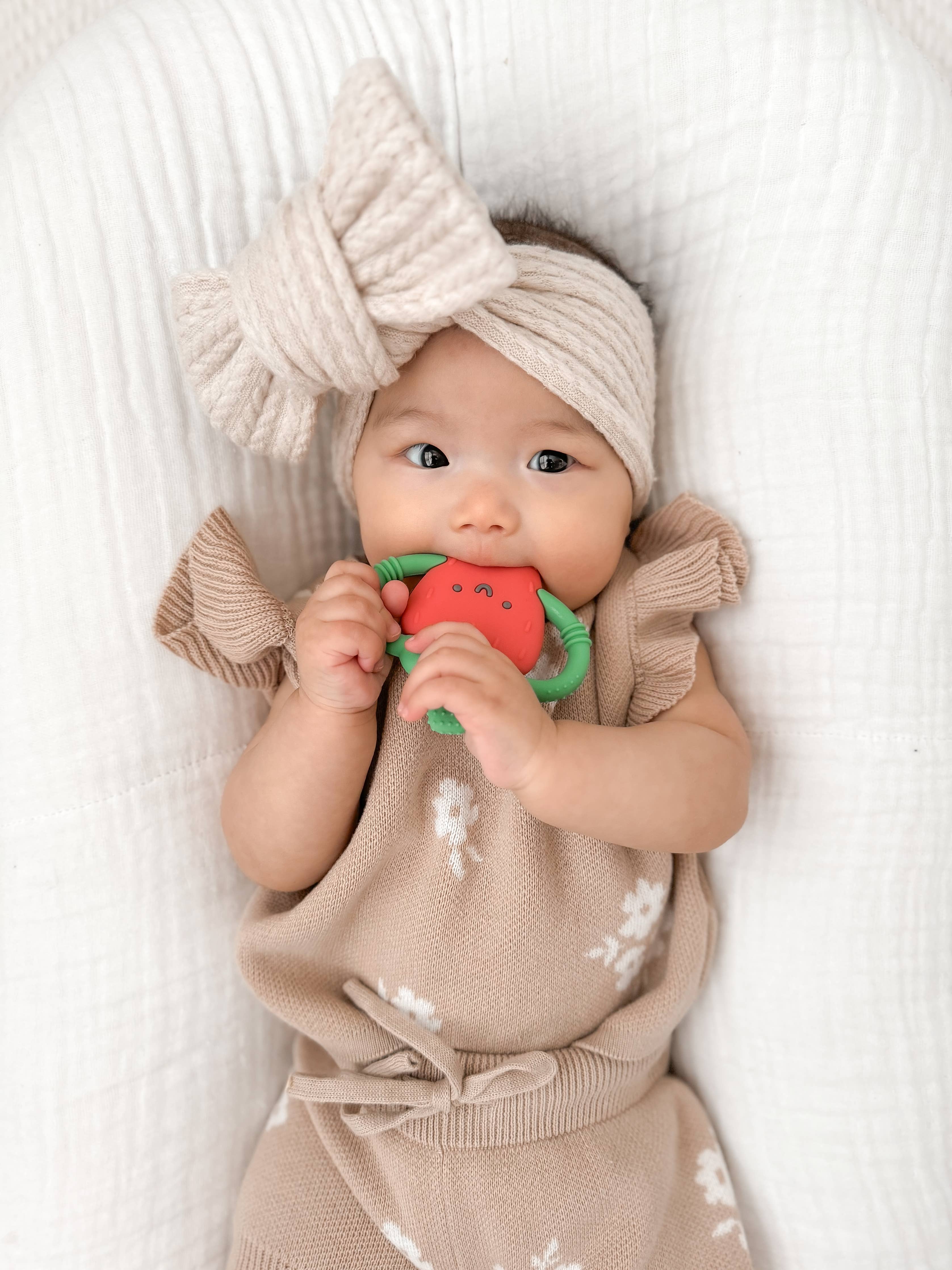 Baby Itzy Ritzy Strawberry Chew Crew Teether with soft, colorful silicone design for soothing teething relief.