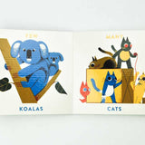 Baby reading the Animal Opposites Board Book by Simon & Schuster, featuring colorful animal illustrations and simple opposites.