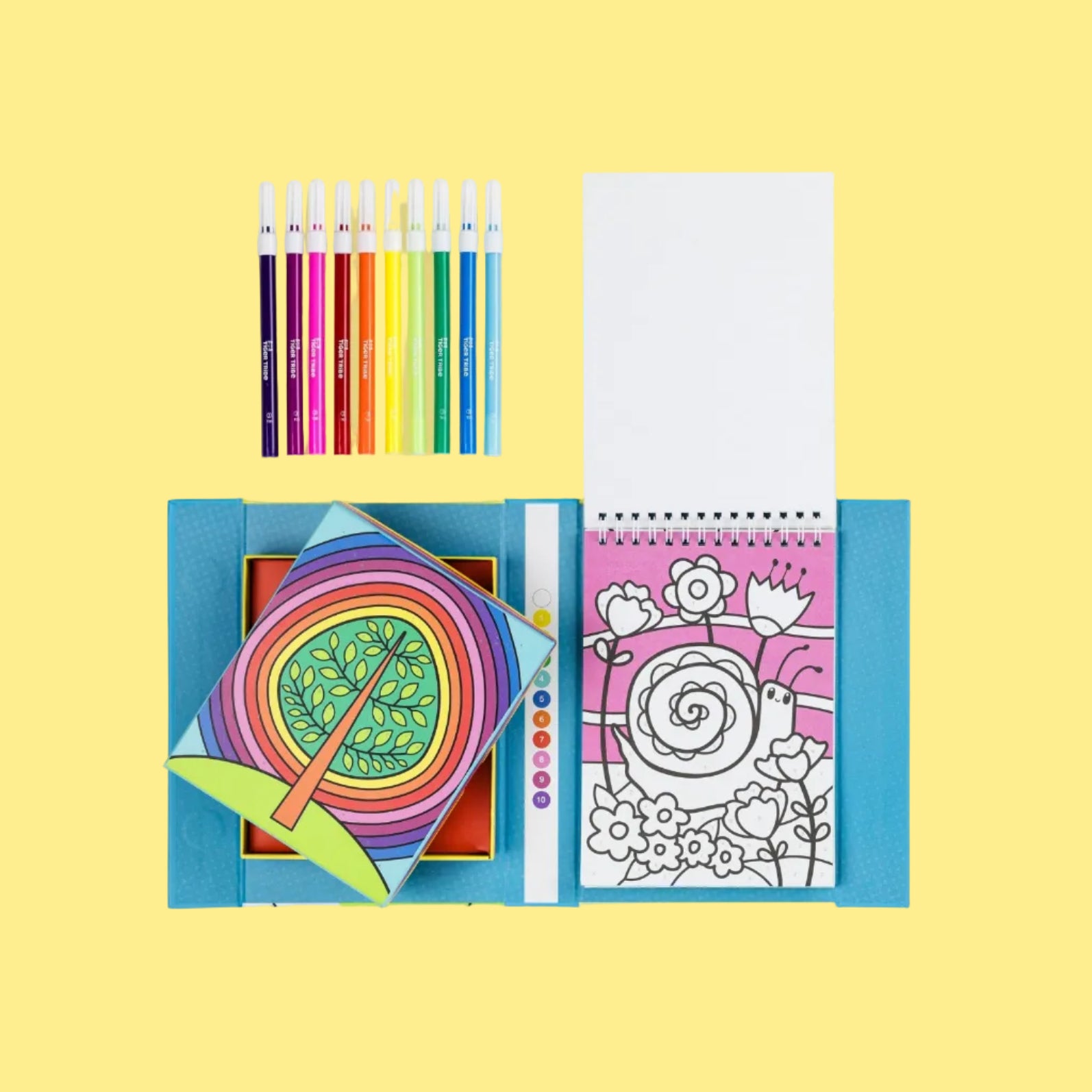 Coloring book with colored pencils on a yellow background