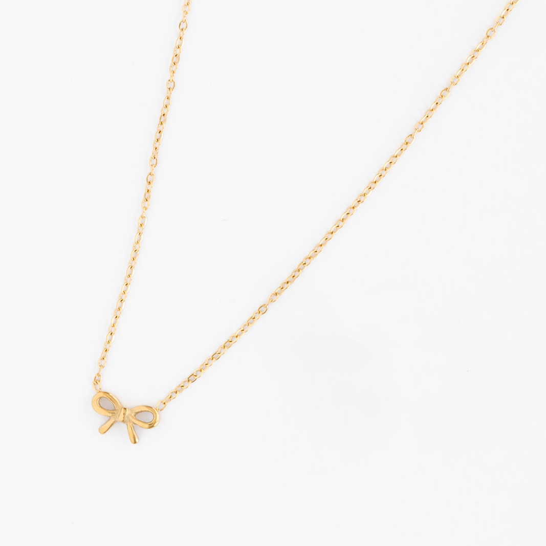 Pip Pop Post Bow Pendant Necklace with a delicate bow charm, stylish accessories for women, silver-tone jewelry, close-up view.