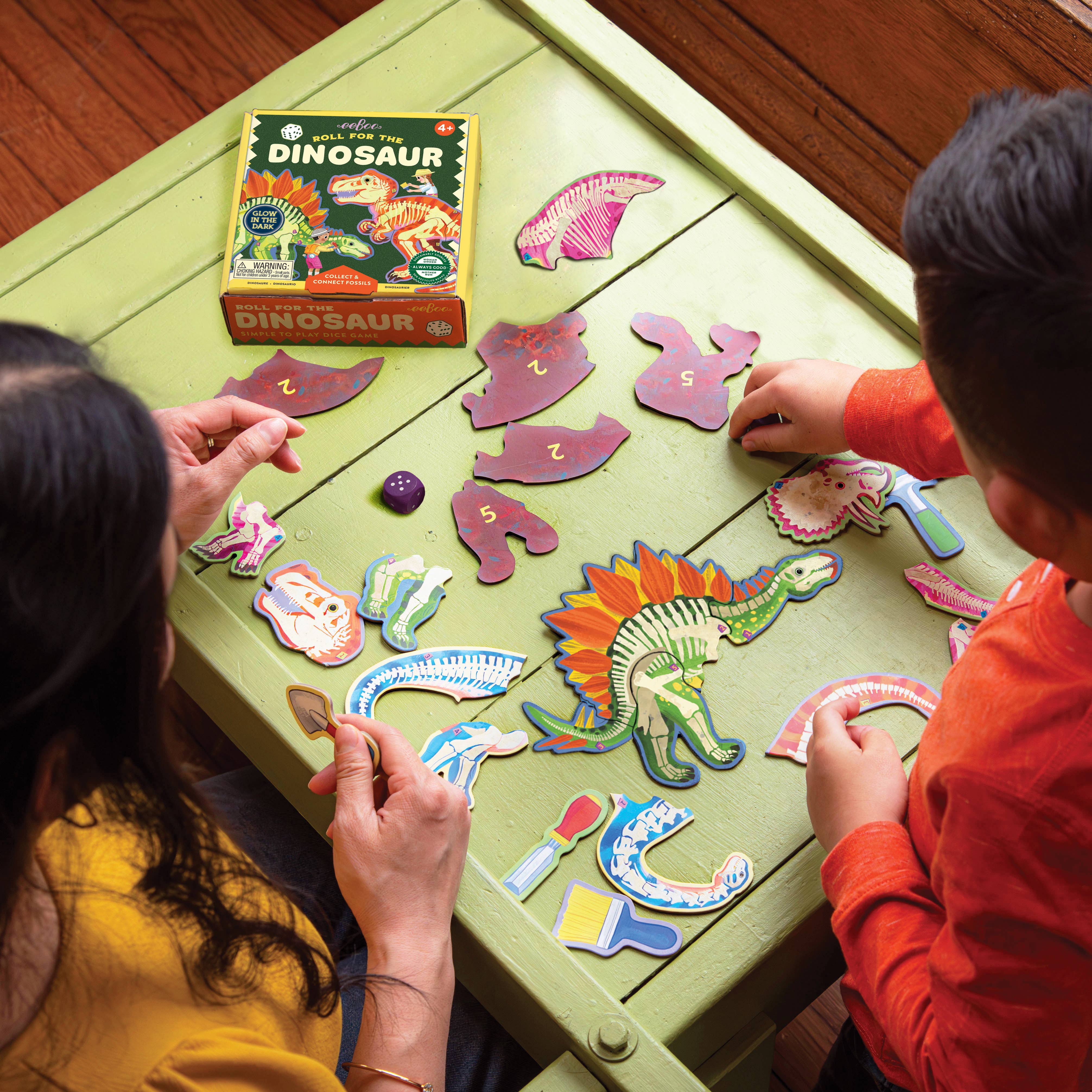 Colorful dinosaur-themed dice roll game from eeBoo featuring vibrant dice and game components for kids' fun and learning.