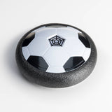 Stomp Sports Hover Soccer ball in action, floating above the ground with colorful LED lights during play.
