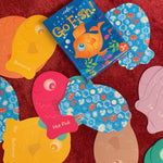 Color Go Fish Card Game by eeBoo showing a deck of colorful illustrated fish-themed playing cards spread out on a surface.