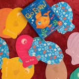 Color Go Fish Card Game by eeBoo showing a deck of colorful illustrated fish-themed playing cards spread out on a surface.