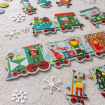 Children's train puzzle with colorful train car pieces on a textured surface.