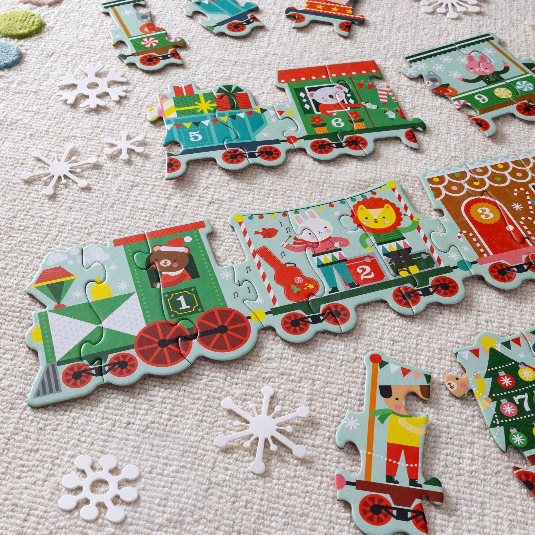 Children's train puzzle with colorful train car pieces on a textured surface.