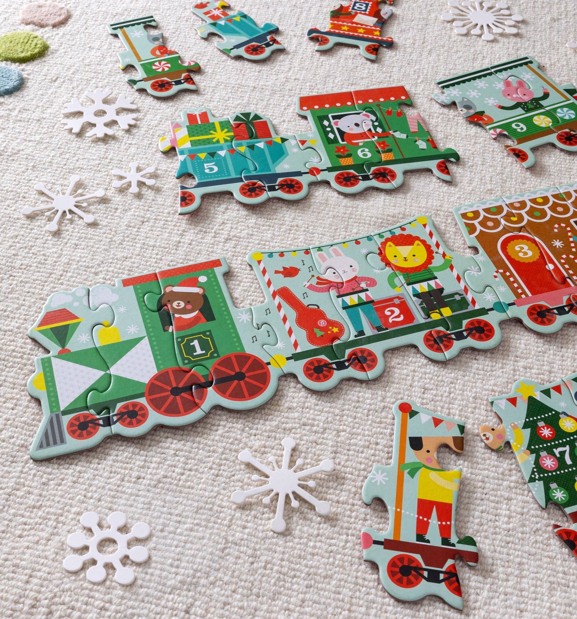 Children's train puzzle with colorful train car pieces on a textured surface.