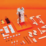 Jumping robot robotics and building kit from KiwiCo's STEAM series, featuring colorful robot parts and tools on a workspace.