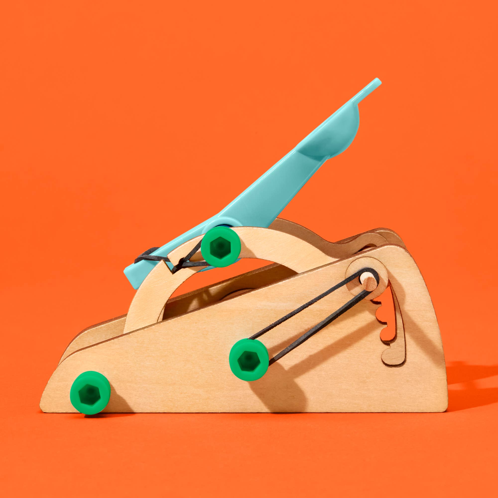 DIY basketball catapult kit by KiwiCo, Inc. featuring colorful parts and assembled catapult ready for fun STEAM STEM activities.