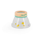 Janod Nature Magnifier for outdoor exploration, showing a child using the magnifier to examine leaves and insects outdoors.