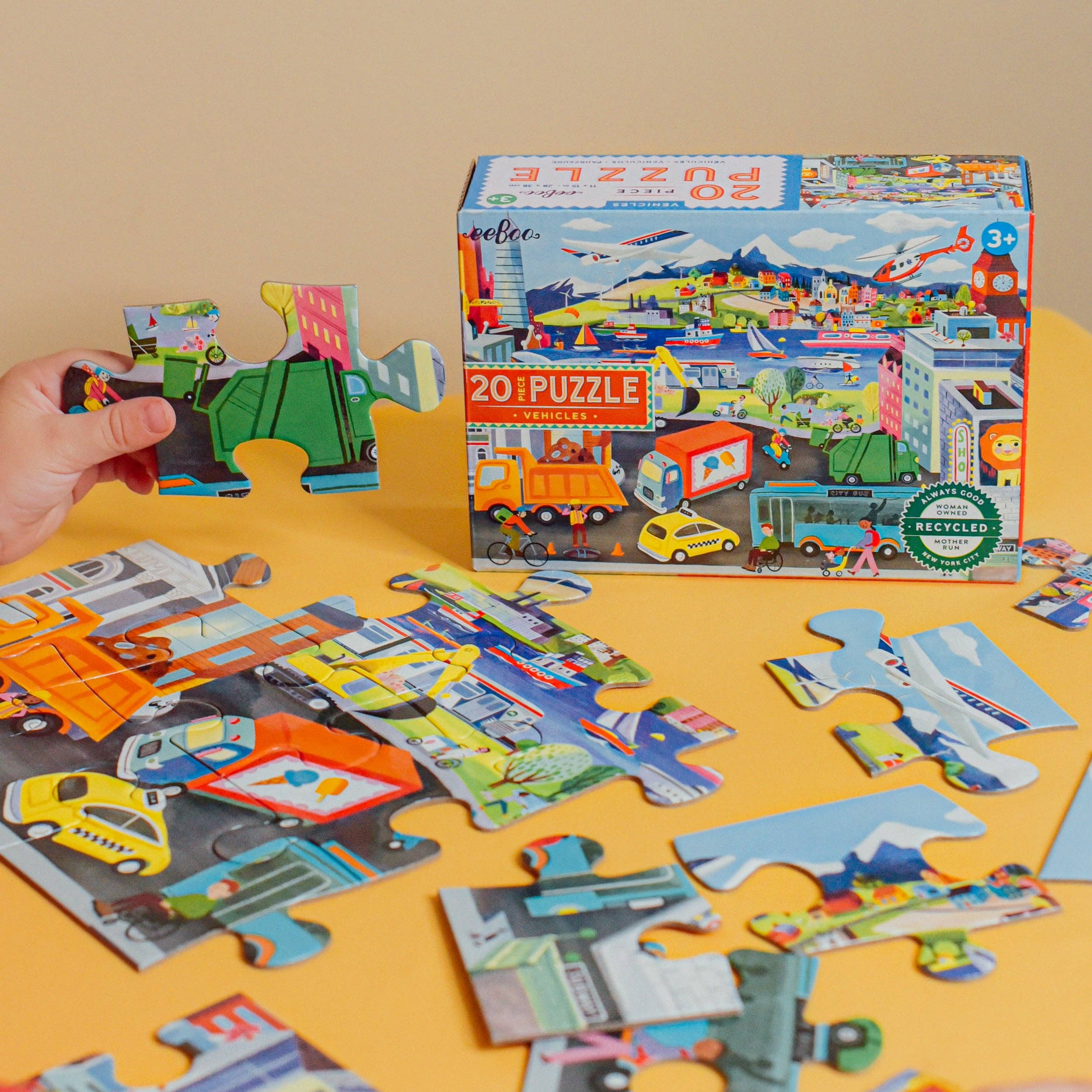 Colorful 20-piece vehicle puzzle by eeBoo featuring various cars, trucks, and buses for children to assemble and enjoy.