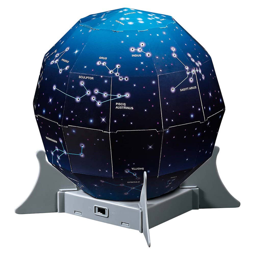 Kidzlabs Night Sky Projector by The Toy Network displaying star and moon images on a child's bedroom wall.