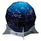 Kidzlabs Night Sky Projector by The Toy Network displaying star and moon images on a child's bedroom wall.