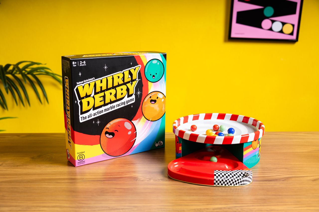 Whirly Derby game by Big Potato Games featuring colorful spinning tops and a wooden game board for fun tabletop entertainment.