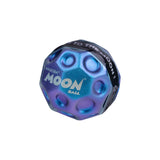 Waboba Metallic Moon Ball outdoors, blue metallic surface, designed for outdoor play and bouncing fun.